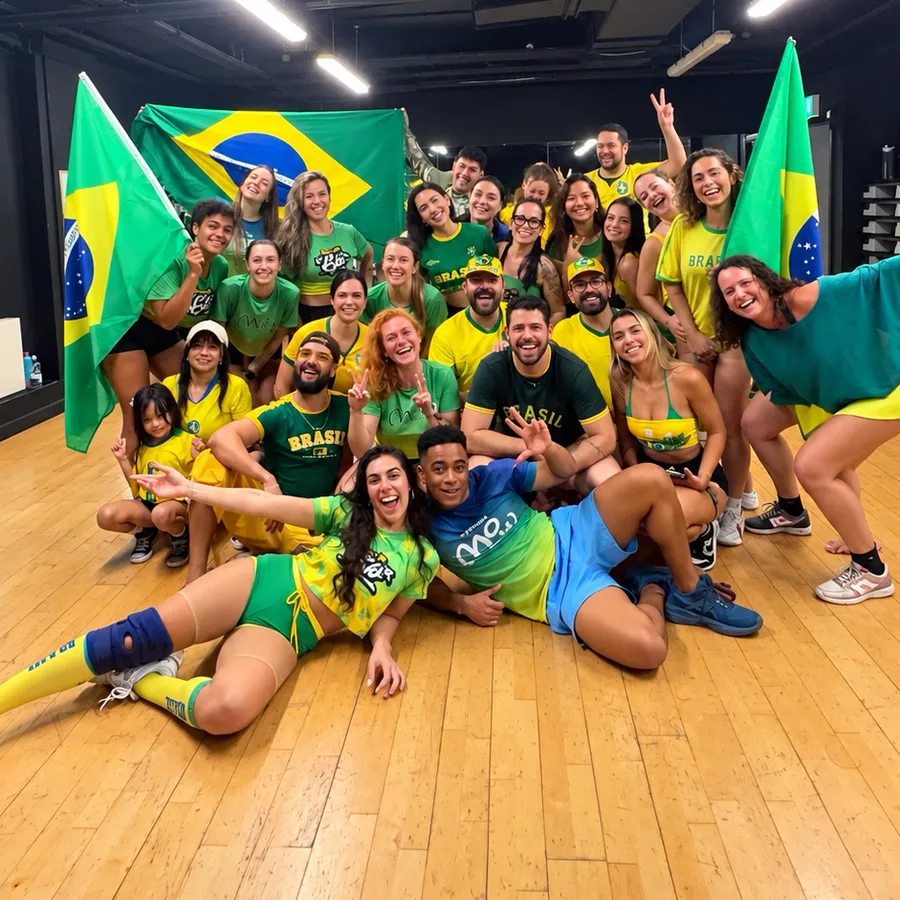 The class in green and yellow Brazil shirts posing with Brazilian flags in the studio